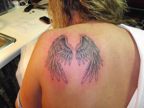 Feather Of Angel On Shoulder