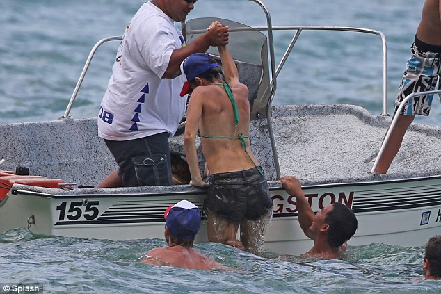 Helping hand: After swimming out to the boat, Nikki is pulled aboard