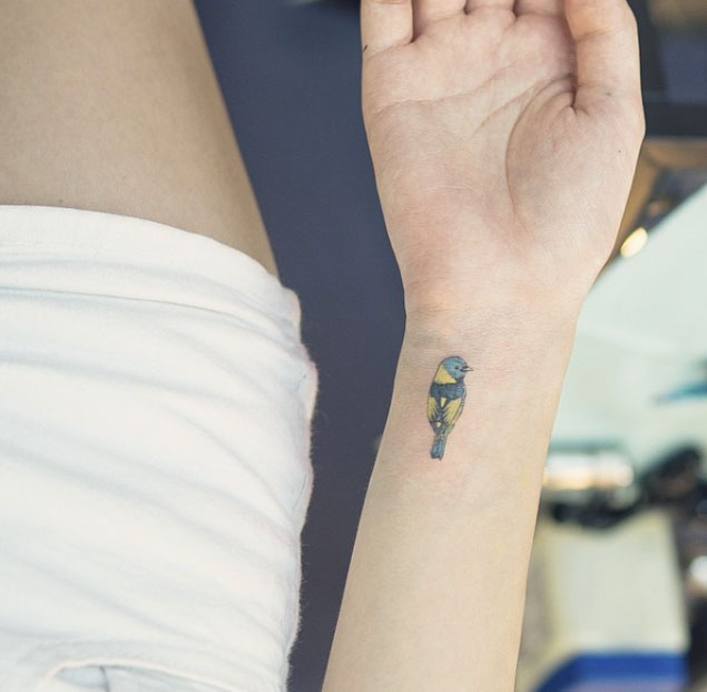 Tiny Bird Tattoo on Wrist by Sol Art