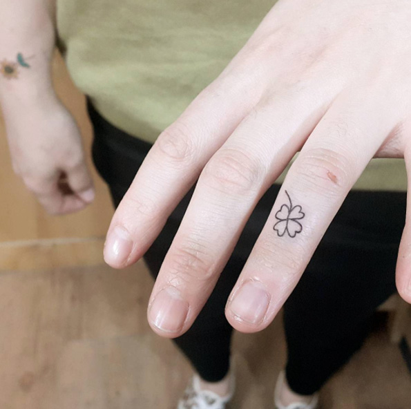 Tiny four leaf clover tattoo on finger by Chaewa