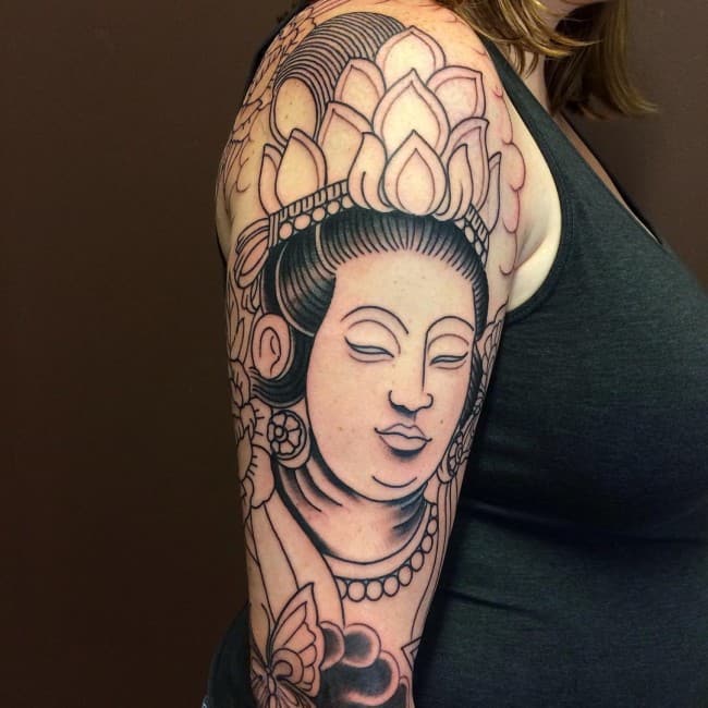 buddha tattoo on upper arm